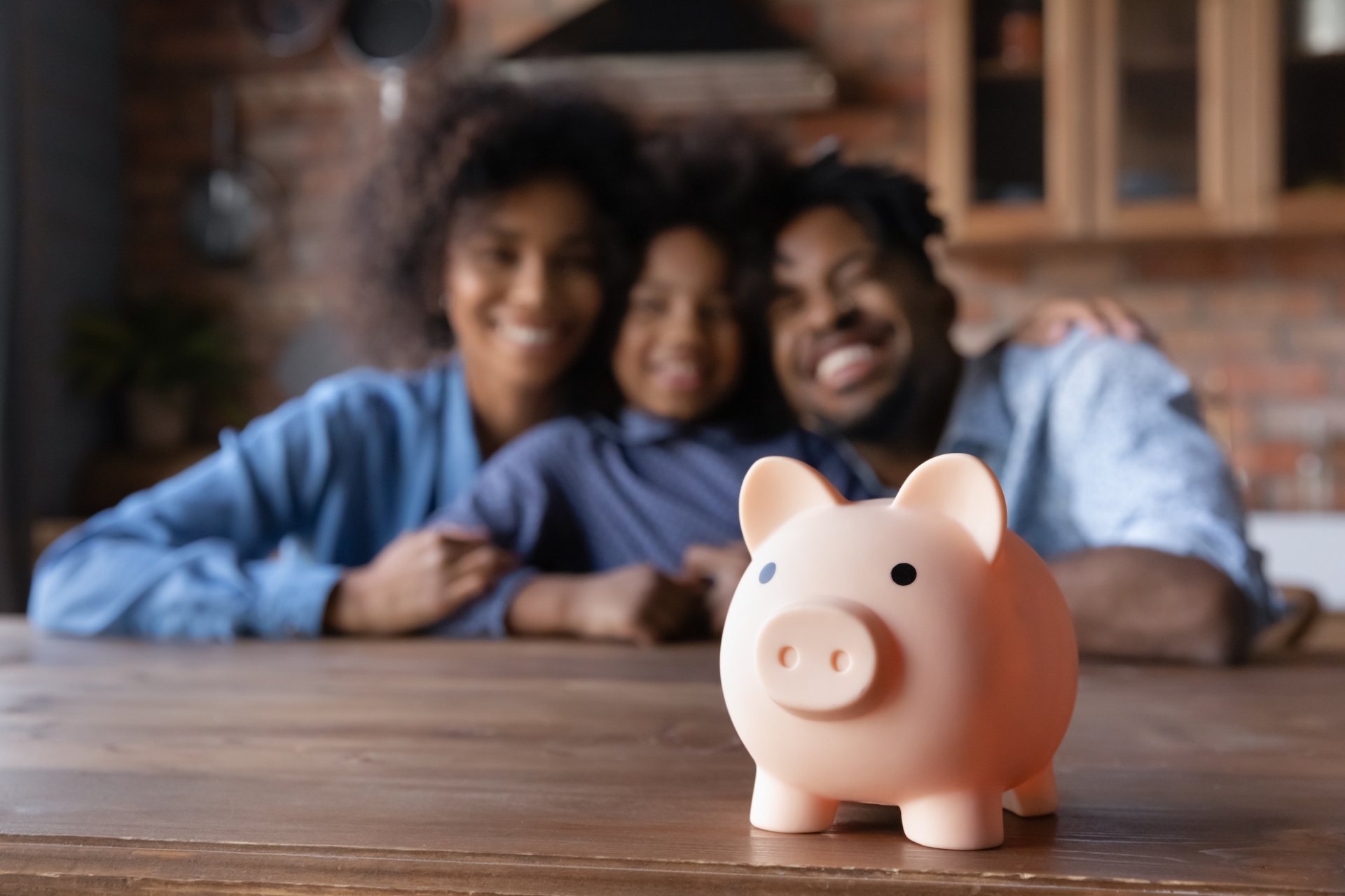 happy family behind a piggy bank representing saving money
